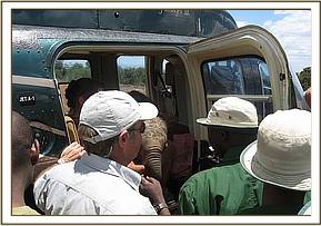 Lesanju being loaded with her rescuers looking on